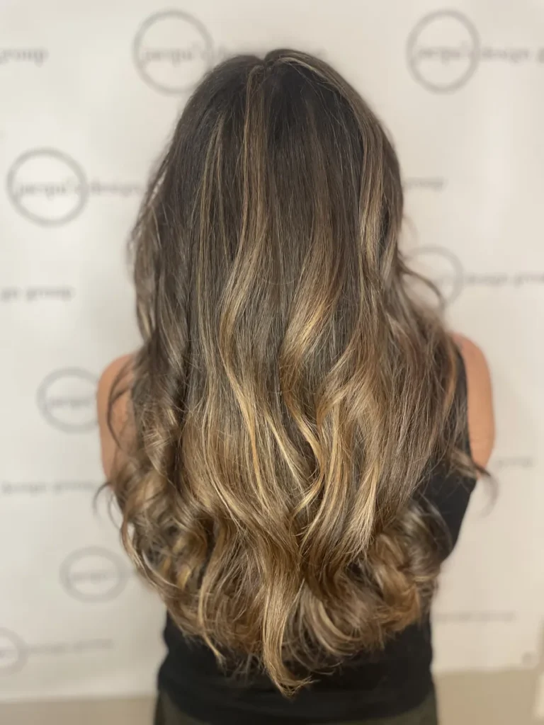 Long bronde balayage with hand-painted caramel ends, done at Jacqui's Design Group in Arlington, MA