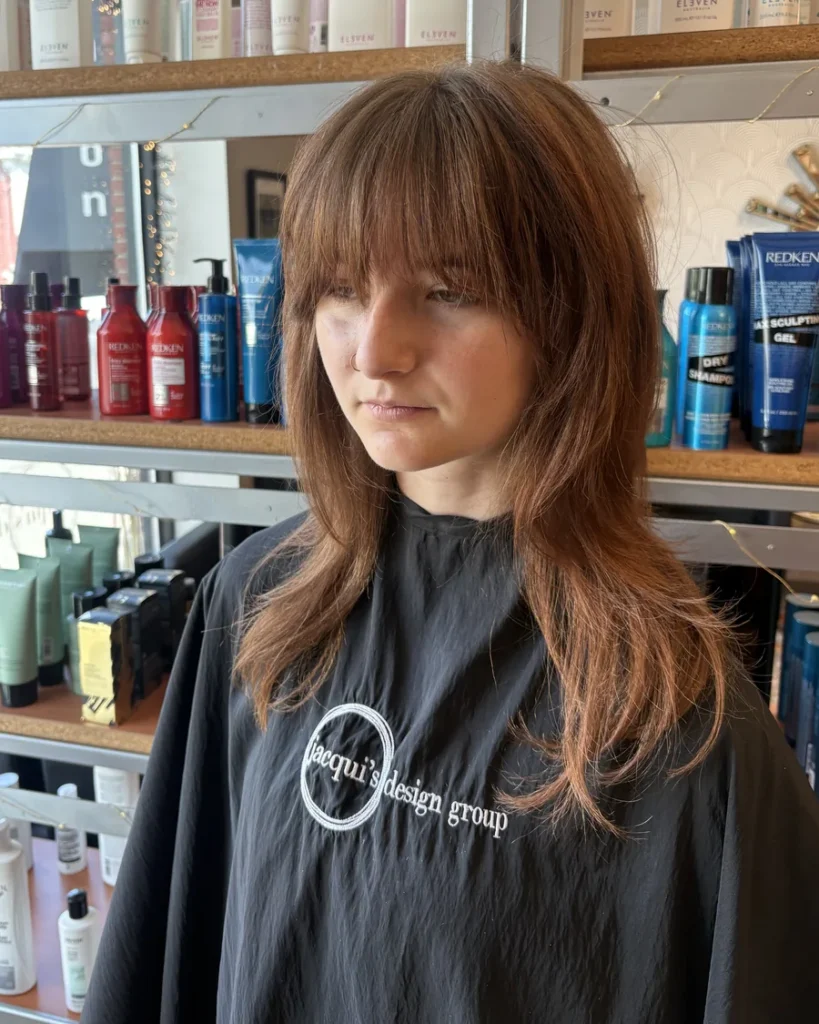 Auburn shag haircut with curtain bangs and soft layers, cut at Jacqui's Design Group in Arlington, MA